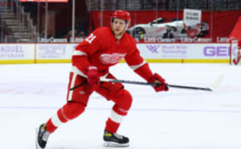 DETROIT, MICHIGAN – APRIL 24: Dennis Cholowski #21 of the Detroit Red Wings skates against the Dallas Stars at Little Caesars Arena on April 24, 2021 in Detroit, Michigan. (Photo by Gregory Shamus/Getty Images)