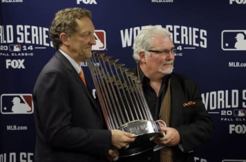 San Francisco Giants general manager Brian Sabean (right) and chief executive officer Larry Baer hold the Commissioners Trophy. Quinn won the trophy twice in his time with the Philadelphia Athletics.