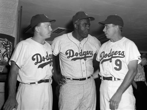 FLUSHING, NEW YORK – JULY 25, 1964: (l to r) Eddie Stanky, Jackie Robinson and Pee Wee Reese, former Brooklyn Dodgers, meet in the lockerroom prior to Old Timer’s Day on July 25, 1964 at Shea Stadium in Flushing, New York. The current Mets faced the Milwaukee Braves in the regular season game that followed the Old Timer’s Day game. (Photo by: Olen Collection/Diamond Images/Getty Images)