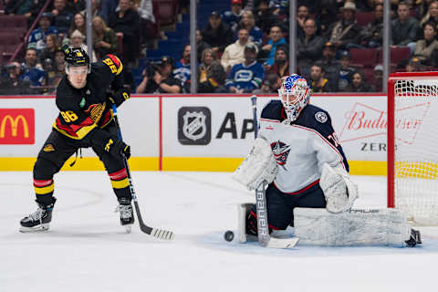 Jan 27, 2023; Vancouver, British Columbia, CAN; Vancouver Canucks forward Andrei Kuzmenko (96) watches the shot from forward Elias Pettersson (40) go through the legs of Columbus Blue Jackets goalie Joonas Korpisalo (70) in the third period at Rogers Arena. Canucks won 5-2. Mandatory Credit: Bob Frid-USA TODAY Sports