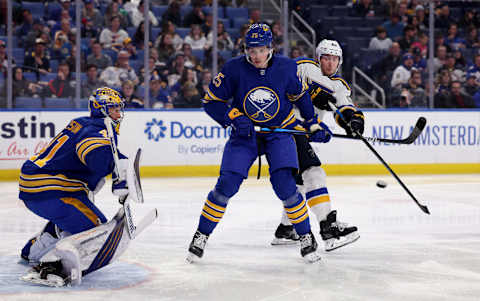 Apr 14, 2022; Buffalo, New York, USA; Buffalo Sabres defenseman Owen Power (25) defends as St. Louis Blues center Ivan Barbashev (49) looks to deflect a shot on Buffalo Sabres goaltender Craig Anderson (41) during the third period at KeyBank Center. Mandatory Credit: Timothy T. Ludwig-USA TODAY Sports