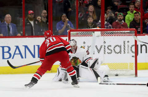 RALEIGH, NC – NOVEMBER 12: Sebastian Aho #20 of the Carolina Hurricanes scores the game winning goal in overtime during an NHL game against the Chicago Blackhawks on November 12, 2018 at PNC Arena in Raleigh, North Carolina. (Photo by Gregg Forwerck/NHLI via Getty Images)