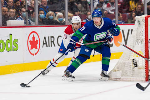 Mar 9, 2022; Vancouver, British Columbia, CAN; Montreal Canadiens defenseman Chris Wideman (20) checks Vancouver Canucks forward Nils Hoglander (21) in the third period at Rogers Arena. Canucks won 5-3. Mandatory Credit: Bob Frid-USA TODAY Sports