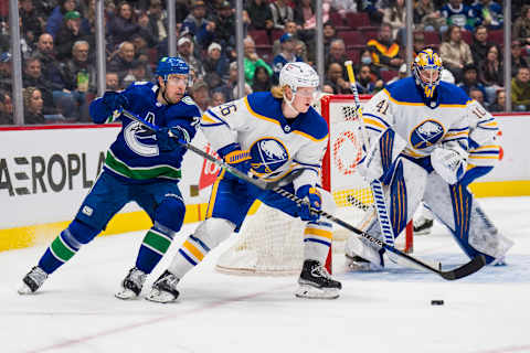 Mar 20, 2022; Vancouver, British Columbia, CAN; Vancouver Canucks forward Tanner Pearson (70) stick checks Buffalo Sabres defenseman Rasmus Dahlin (26) in the third period at Rogers Arena. Sabres won 3-2 in overtime. Mandatory Credit: Bob Frid-USA TODAY Sports