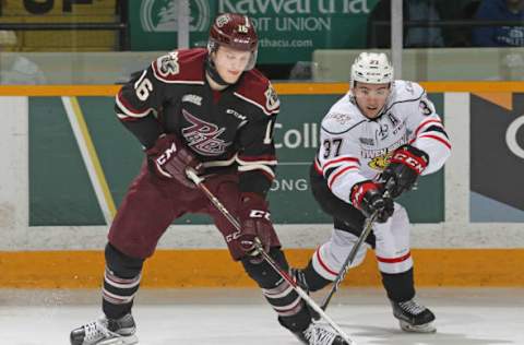 PETERBOROUGH, ON – MARCH 2: Nick Suzuki #37 of the Owen Sound Attack looks to check Steven Lorentz #16 of the Peterborough Petes during an OHL game at the Peterborough Memorial Centre on March 2, 2017 in Peterborough, Ontario, Canada. The Petes defeated the Attack 5-4 in overtime. (Photo by Claus Andersen/Getty Images)