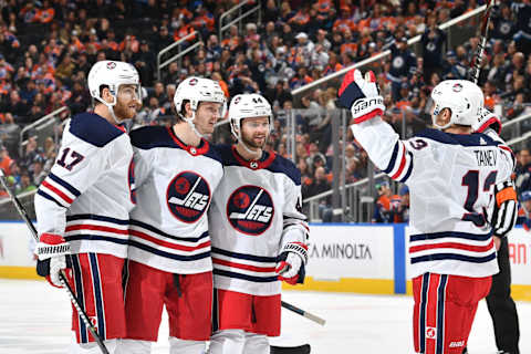 EDMONTON, AB – DECEMBER 31: Adam Lowry, #17, Jacob Trouba #8, Josh Morrissey #44 and Brandon Tanev #13 of the Winnipeg Jets celebrate after a goal during the game against the Edmonton Oilers on December 31, 2018 at Rogers Place in Edmonton, Alberta, Canada. (Photo by Andy Devlin/NHLI via Getty Images)