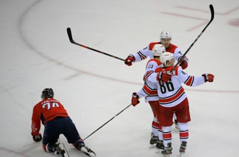 WASHINGTON, DC – APRIL 24: Washington Capitals defenseman John Carlson (74) gets back on his feet as Carolina Hurricanes left wing Brock McGinn (23) celebrates his 2nd period goal during a game between the the Washington Capitals and the Carolina Hurricanes in game 7 of the the Stanley Cup eastern division quarter finals at 3 games each in Washington, DC on April 24, 2019 . (Photo by John McDonnell/The Washington Post via Getty Images)