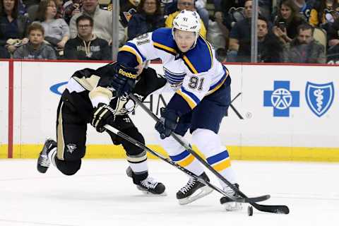 Mar 24, 2015; Pittsburgh, PA, USA; St. Louis Blues right wing Vladimir Tarasenko (91) handles the puck as Pittsburgh Penguins defenseman Paul Martin (L) defends during the first period at the CONSOL Energy Center. Mandatory Credit: Charles LeClaire-USA TODAY Sports