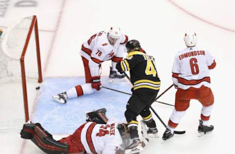 David Krejci #46 of the Boston Bruins scores at 57 seconds of the third period against Petr Mrazek #34 of the Carolina Hurricanes (Photo by Elsa/Getty Images)