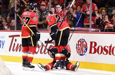 Dec 2, 2016; Calgary, Alberta, CAN; Calgary Flames right wing Kris Versteeg (10) celebrates his first period goal with right wing Michael Frolik (67) and center Sean Monahan (23) against the Minnesota Wild at Scotiabank Saddledome. Mandatory Credit: Candice Ward-USA TODAY Sports