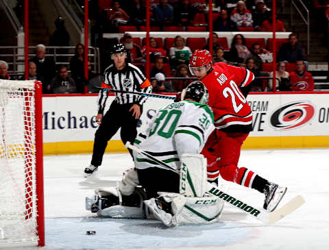 RALEIGH, NC – NOVEMBER 13: Sebastian Aho #20 of the Carolina Hurricanes slips the puck five-hole past Ben Bishop #30 of the Dallas Stars to score a first period goal during an NHL game on November 13, 2017 at PNC Arena in Raleigh, North Carolina. (Photo by Gregg Forwerck/NHLI via Getty Images)