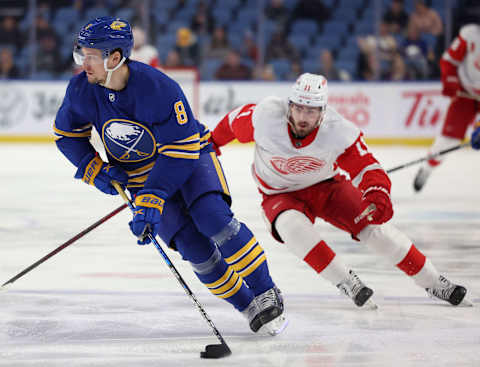 Jan 17, 2022; Buffalo, New York, USA; Buffalo Sabres defenseman Robert Hagg (8) looks to make a pass as Detroit Red Wings right wing Filip Zadina (11) defends during the first period at KeyBank Center. Mandatory Credit: Timothy T. Ludwig-USA TODAY Sports