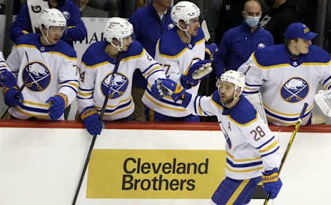 Dec 17, 2021; Pittsburgh, Pennsylvania, USA; Buffalo Sabres left wing Zemgus Girgensons (28) celebrates his goal with the Sabres bench against the Pittsburgh Penguins during the second period at PPG Paints Arena. Mandatory Credit: Charles LeClaire-USA TODAY Sports