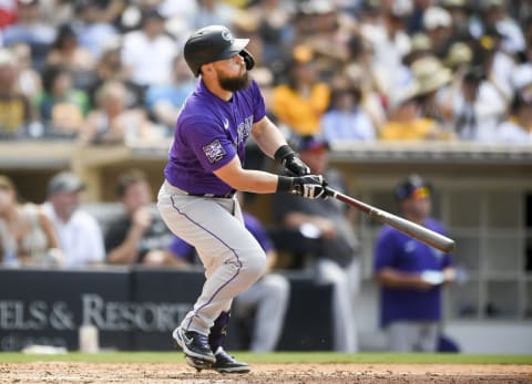 SAN DIEGO, CA – JULY 11: Chris Owings #12 of the Colorado Rockies hits a solo home run during the seventh inning of a baseball game agains the San Diego Padres at Petco Park on July 11, 2021 in San Diego, California. (Photo by Denis Poroy/Getty Images)