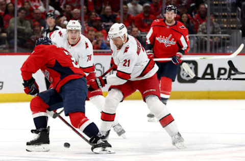 WASHINGTON, DC – MARCH 03: Nino Niederreiter #21 of the Carolina Hurricanes and Nick Jensen #3 of the Washington Capitals go after the puck in the first period at Capital One Arena on March 03, 2022, in Washington, DC. (Photo by Rob Carr/Getty Images)