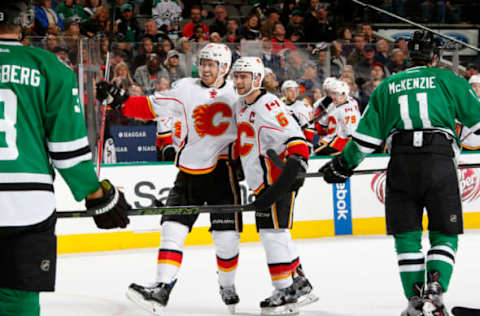 DALLAS, TX – DECEMBER 6: Dougie Hamilton #27, Mark Giordano #5 and the Calgary Flames celebrate a goal against the Dallas Stars. Photo by Glenn James/NHLI via Getty Images)