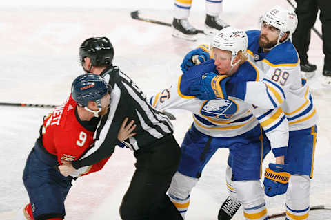 SUNRISE, FL – APRIL 8: Alex Tuch #89 grabs a hold of Rasmus Dahlin #26 of the Buffalo Sabres as linesman Kilian McNamara #93 holds Sam Bennett #9 of the Florida Panthers as they try to fight at the FLA Live Arena on April 8, 2022 in Sunrise, Florida. (Photo by Joel Auerbach/Getty Images)