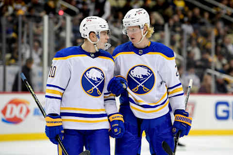 PITTSBURGH, PENNSYLVANIA – DECEMBER 17: Henri Jokiharju #10 talks to Rasmus Dahlin #26 of the Buffalo Sabres during the third period of a game against the Pittsburgh Penguins at PPG PAINTS Arena on December 17, 2021 in Pittsburgh, Pennsylvania. (Photo by Emilee Chinn/Getty Images)