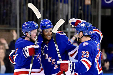 NEW YORK, NEW YORK – FEBRUARY 15: K’Andre Miller #79 of the New York Rangers is congratulated by Alexis Lafreniere #13 and Adam Fox #23 after scoring the game-winning shootout goal against the Boston Bruins at Madison Square Garden on February 15, 2022 in New York City. (Photo by Steven Ryan/Getty Images)