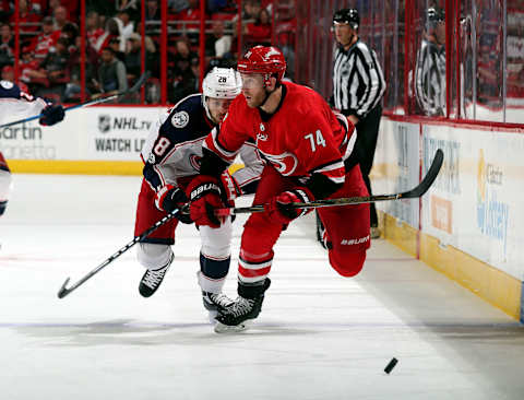 RALEIGH, NC – OCTOBER 10: Jaccob Slavin #74 of the Carolina Hurricanes and Oliver Bjorkstrand #28 of the Columbus Blue Jackets chase down a bouncing puck during an NHL game on October 10, 2017 at PNC Arena in Raleigh, North Carolina. (Photo by Gregg Forwerck/NHLI via Getty Images)