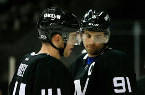 Mar 16, 2017; Brooklyn, NY, USA; New York Islanders defenseman Thomas Hickey (14) talks to New York Islanders center John Tavares (91) before a third period face off at Barclays Center. The Jets won 4-2. Mandatory Credit: Noah K. Murray-USA TODAY Sports