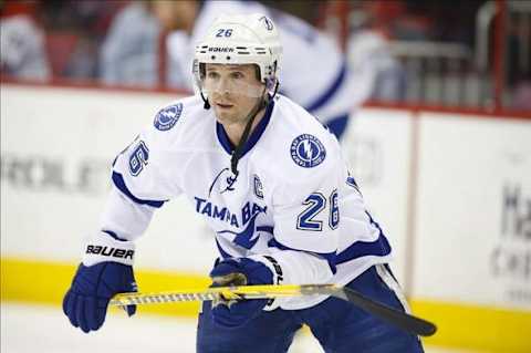 Jan 19, 2014; Raleigh, NC, USA; Tampa Bay Lightning forward Martin St. Louis (26) looks on before the game against the Carolina Hurricanes at PNC Arena. The Tampa Bay Lightning defeated the Carolina Hurricanes 5-3. Mandatory Credit: James Guillory-USA TODAY Sports