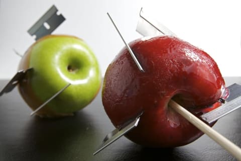 Razors embedded in two candy apples