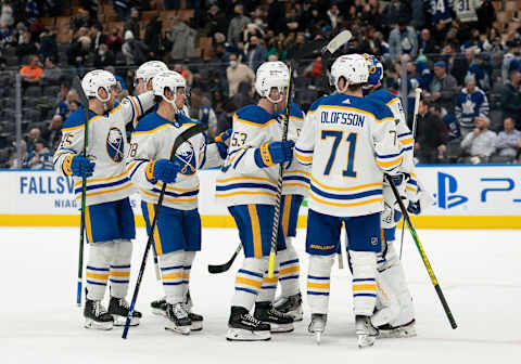 Mar 2, 2022; Toronto, Ontario, CAN; Buffalo Sabres goaltender Craig Anderson (41) celebrates the win with left wing Victor Olofsson (71) and left wing Jeff Skinner (53) against the Toronto Maple Leafs at Scotiabank Arena. Mandatory Credit: Nick Turchiaro-USA TODAY Sports