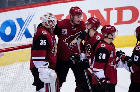 NHL Power Rankings: Arizona Coyotes goalie Louis Domingue (35) celebrates with teammates after beating the San Jose Sharks 3-2 at Gila River Arena. Mandatory Credit: Matt Kartozian-USA TODAY Sports