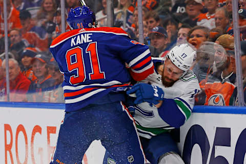 Oct 14, 2023; Edmonton, Alberta, CAN; Edmonton Oilers forward Evander Kane (91) shows a hit on Vancouver Canucks defensemen Filipe Hornek (17) during the first period at Rogers Place. Mandatory Credit: Perry Nelson-USA TODAY Sports