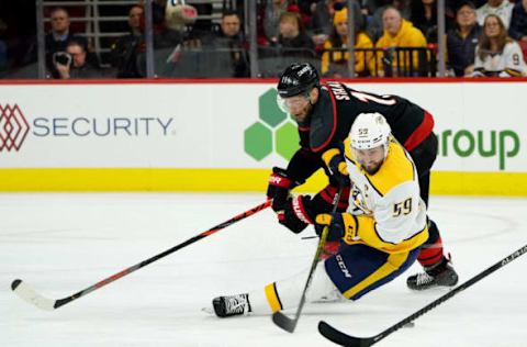 RALEIGH, NC – NOVEMBER 29: Jordan Staal #11 of the Carolina Hurricanes and Roman Josi #59 of the Nashville Predators get tangled up during an NHL game on November 29, 2019 at PNC Arena in Raleigh, North Carolina. (Photo by Gregg Forwerck/NHLI via Getty Images)