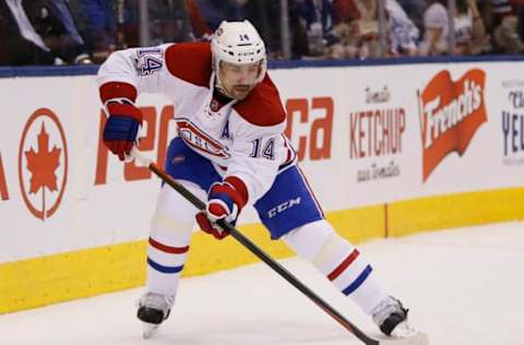 Feb 25, 2017; Toronto, Ontario, CAN; Montreal Canadiens forward Tomas Plekanec (14) passes the puck against the Toronto Maple Leafs at the Air Canada Centre. Montreal defeated Toronto 3-2 in overtime. Mandatory Credit: John E. Sokolowski-USA TODAY Sports