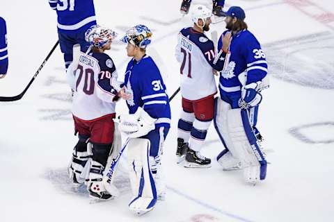 TORONTO, ONTARIO – AUGUST 09: Joonas Korpisalo #70 and Nick Foligno #71 of the Columbus Blue Jackets shake hands with Frederik Andersen #31 and Jack Campbell #36 of the Toronto Maple Leafs. (Photo by Andre Ringuette/Freestyle Photo/Getty Images)