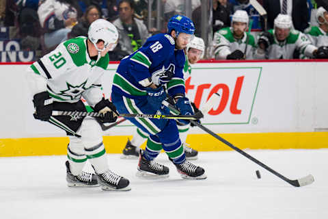 Apr 18, 2022; Vancouver, British Columbia, CAN; Vancouver Canucks forward Jason Dickinson (18) controls the puck against Dallas Stars defenseman Ryan Suter (20) in the first period at Rogers Arena. Mandatory Credit: Bob Frid-USA TODAY Sports