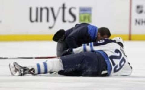 A trainer attends to Winnipeg Jets right wing Patrik Laine (29) after being checked by Buffalo Sabres defenseman Jake McCabe  – Timothy T. Ludwig-USA TODAY Sports