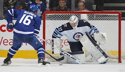 TORONTO,ON – JANUARY 8: Connor Hellebuyck #37 of the Winnipeg Jets stops Mitchell Marner  (Photo by Claus Andersen/Getty Images)