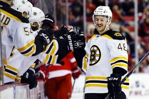 Nov 25, 2015; Detroit, MI, USA; Boston Bruins defenseman Colin Miller (48) receives congratulations from teammates after scoring in the third period against the Detroit Red Wings at Joe Louis Arena. Boston won 2-3 in overtime. Mandatory Credit: Rick Osentoski-USA TODAY Sports