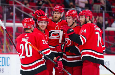 May 4, 2021; Raleigh, North Carolina, USA; Carolina Hurricanes right wing Andrei Svechnikov (37) is congratulated by defenseman Jaccob Slavin (74) defenseman Jani Hakanpaa (58) left wing Teuvo Teravainen (86) and right wing Sebastian Aho (20) after his second period goal against the Chicago Blackhawks at PNC Arena. Mandatory Credit: James Guillory-USA TODAY Sports