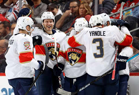 NEWARK, NEW JERSEY – FEBRUARY 11: Frank Vatrano #77 of the Florida Panthers is congratulated by teammates Colton Sceviour #7,Dominic Toninato #14 and Keith Yandle #3 after he scored in the second period against the New Jersey Devils at Prudential Center on February 11, 2020 in Newark, New Jersey. (Photo by Elsa/Getty Images)