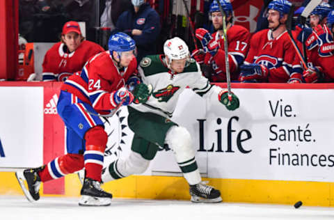 MONTREAL, QC – APRIL 19: Tyler Pitlick #24 of the Montreal Canadiens and Nick Bjugstad #27 of the Minnesota Wild skate after the puck during the first period at Centre Bell on April 19, 2022 in Montreal, Canada. (Photo by Minas Panagiotakis/Getty Images)