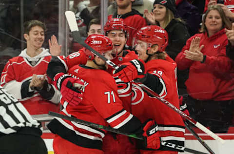 RALEIGH, NC – JANUARY 21: Carolina Hurricanes Left Wing Ryan Dzingel (18) and Carolina Hurricanes Center Lucas Wallmark (71) congratulate Carolina Hurricanes Right Wing Martin Necas (88) after scoring during a game between the Carolina Hurricanes and the Winnipeg Jets on January 21, 2020 at the PNC Arena in Raleigh, NC. (Photo by Greg Thompson/Icon Sportswire via Getty Images)