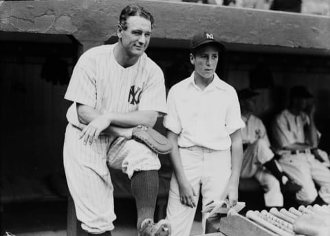 BRONX, NY – 1937: Lou Gehrig #4 of the New York Yankees and a young fan pose on the dugout steps during the 1937 season at Yankee Stadium in the Bronx, New York. (Photo by Kidwiler Collection/Diamond Images/Getty Images)