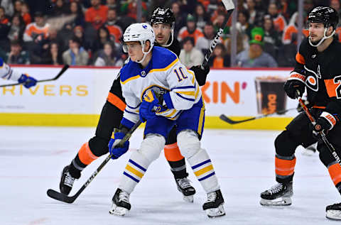 Mar 17, 2023; Philadelphia, Pennsylvania, USA; Buffalo Sabres defenseman Henri Jokiharju (10) fights for position with Philadelphia Flyers center Tanner Laczynski (58) in the third period at Wells Fargo Center. Mandatory Credit: Kyle Ross-USA TODAY Sports