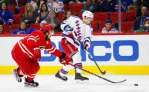 New York Rangers forward J. T. Miller (10) takes a third period shot against Carolina Hurricanes defensemen Justin Faulk (27) (James Guillory-USA TODAY Sports)