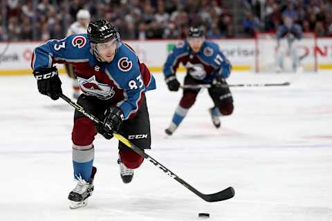 DENVER, COLORADO – APRIL 17: Matt Nieto #83 of the Colorado Avalanche advances the puck against the Calgary Flames in overtime during Game Four of the Western Conference First Round during the 2019 NHL Stanley Cup Playoffs at the Pepsi Center on April 17, 2019 in Denver, Colorado. (Photo by Matthew Stockman/Getty Images)