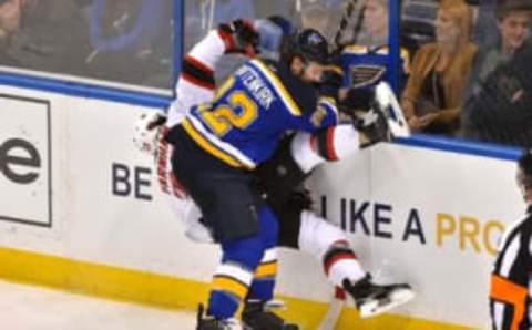 Jan 12, 2016; St. Louis, MO, USA; St. Louis Blues defenseman Kevin Shattenkirk (22) checks New Jersey Devils right wing Bobby Farnham (23) during the third period at Scottrade Center. The Blues won 5-2. Mandatory Credit: Jasen Vinlove-USA TODAY Sports