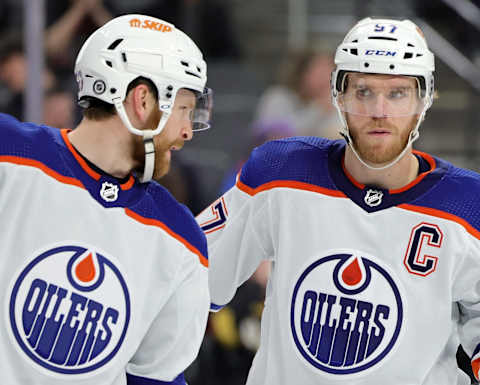 Brett Kulak #27 and Connor McDavid #97 of the Edmonton Oilers talk on the ice in the second period of a game against the Vegas Golden Knights at T-Mobile Arena on January 14, 2023 in Las Vegas, Nevada. (Photo by Ethan Miller/Getty Images)