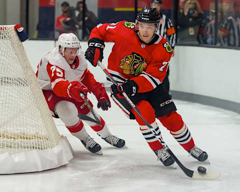 TRAVERSE CITY, MI – SEPTEMBER 06: Philipp Kurashev #71 of the Chicago Blackhawks skates around the net in front of Troy Loggins #75 of the Detroit Red Wings of the during Day-1 of the NHL Prospects Tournament at Centre Ice Arena on September 6, 2019 in Traverse City, Michigan. (Photo by Dave Reginek/NHLI via Getty Images) *** Philipp Kurashev; Troy Loggins