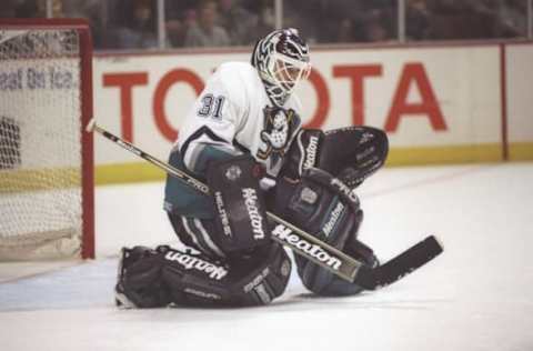 Anaheim, CA: Goaltender Guy Hebert of the Anaheim Mighty Ducks blocks a shot during a game against the Chicago Blackhawks at Arrowhead Pond on November 24, 1995. The Blackhawks won the game, 5-4. Mandatory Credit: Glenn Cratty /Allsport