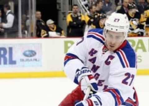 Mar 3, 2016; Pittsburgh, PA, USA; New York Rangers defenseman Ryan McDonagh (27) gathers the puck against the Pittsburgh Penguins during the second period at the CONSOL Energy Center. Mandatory Credit: Charles LeClaire-USA TODAY Sports